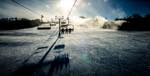 the view from seated on a chairlift being carried toward the sun at the top of the mountain, Blue Mountain ontario canada.