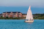 sailboat in the foreground with the Collingwood Shipyard Development in the background