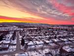 sunset view of collingwood from its residential tree streets neighbourhoods, looking toward the mountain and sunset on a winter evening