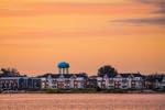 a view of the Collingwood Shipyards Development with the watertower bearing the town's name in the background. sunset view